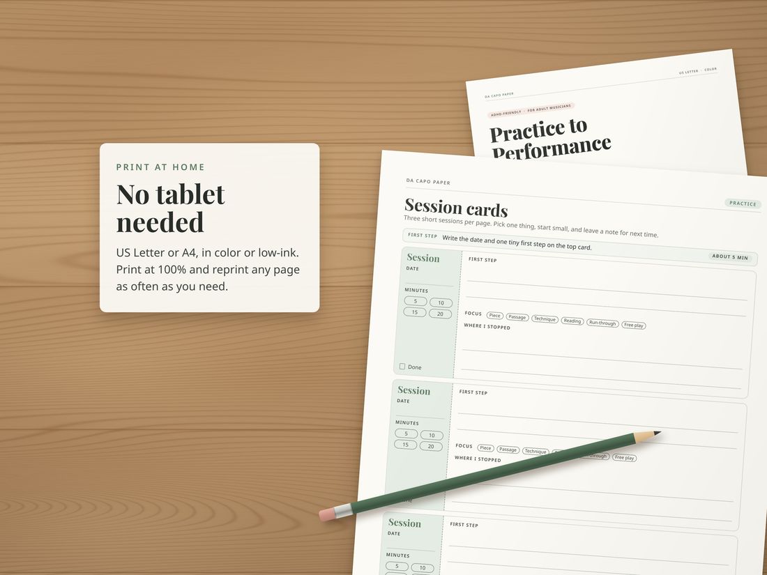 Printed Music Practice Journal pages on a wooden desk with a pencil.